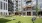 Open-air picnic retreat at The Shipwright in Lynn, MA featuring a spacious turf lawn, Adirondack chairs, cornhole setup, and direct access to indoor amenities